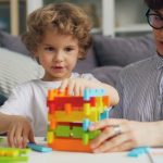 a man and a child playing with a building set